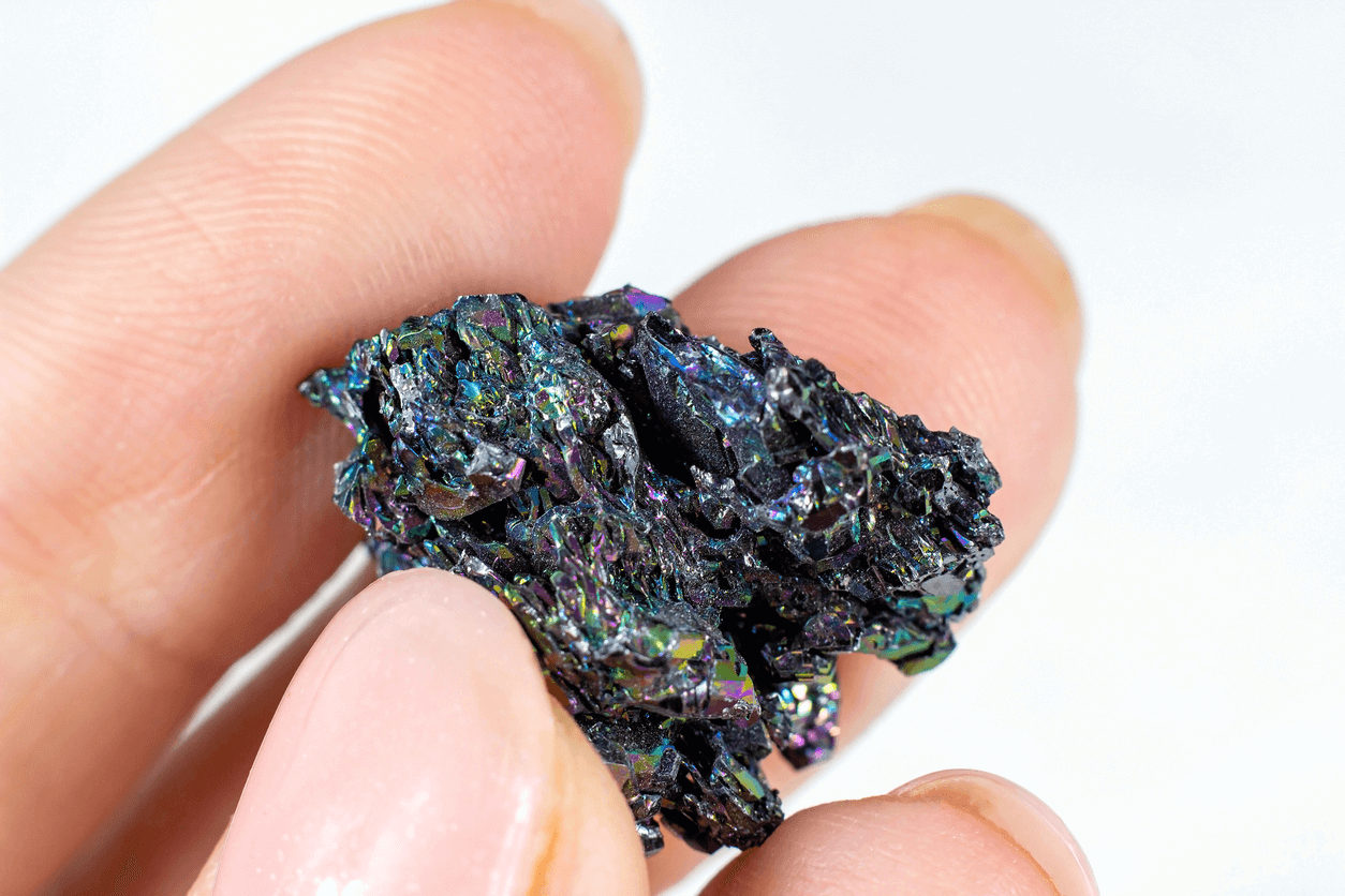  A Closeup of a Woman's Hand Holding a Silicon Carbide (SiC) crystal (aka Carborundum or Moissanite)